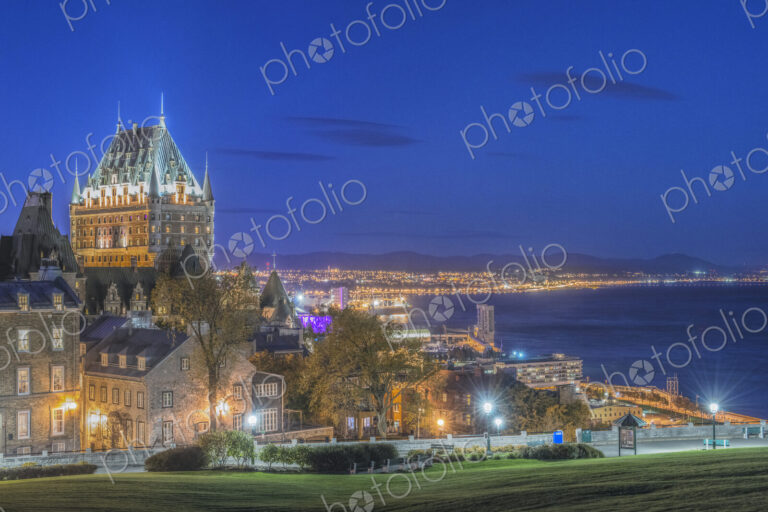 Chateau Frontenac, lit up at night in Quebec City, view over the St Lawrence river.