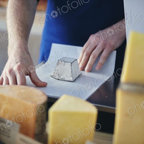 Cheeseseller wrapping up goats cheese