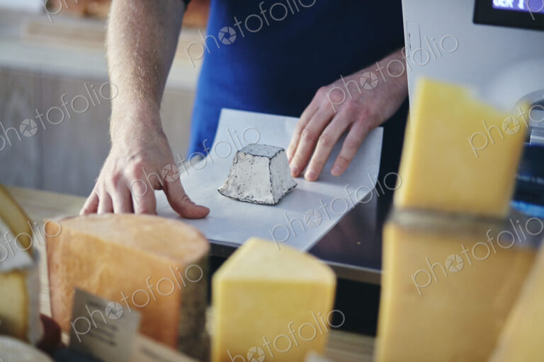 Cheeseseller wrapping up goats cheese