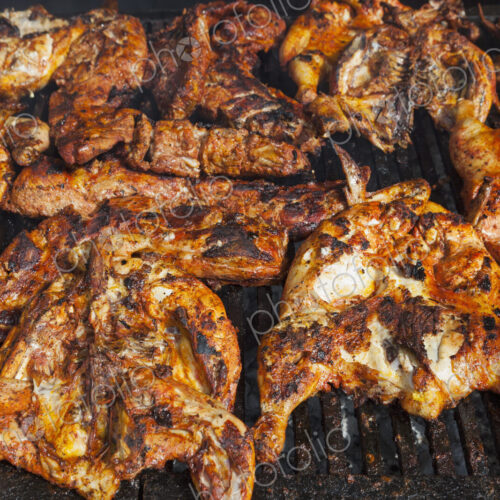 Chickens cooking on a barbeque grill Chickens cooking on a barbeque grill