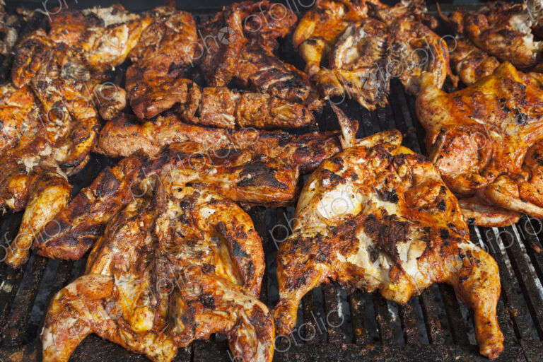 Chickens cooking on a barbeque grill