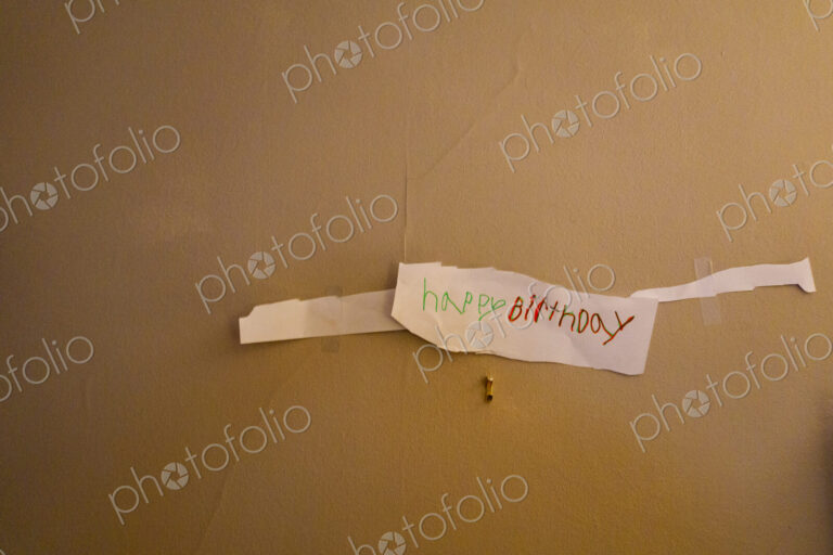 Child drawn happy birthday sign on wall