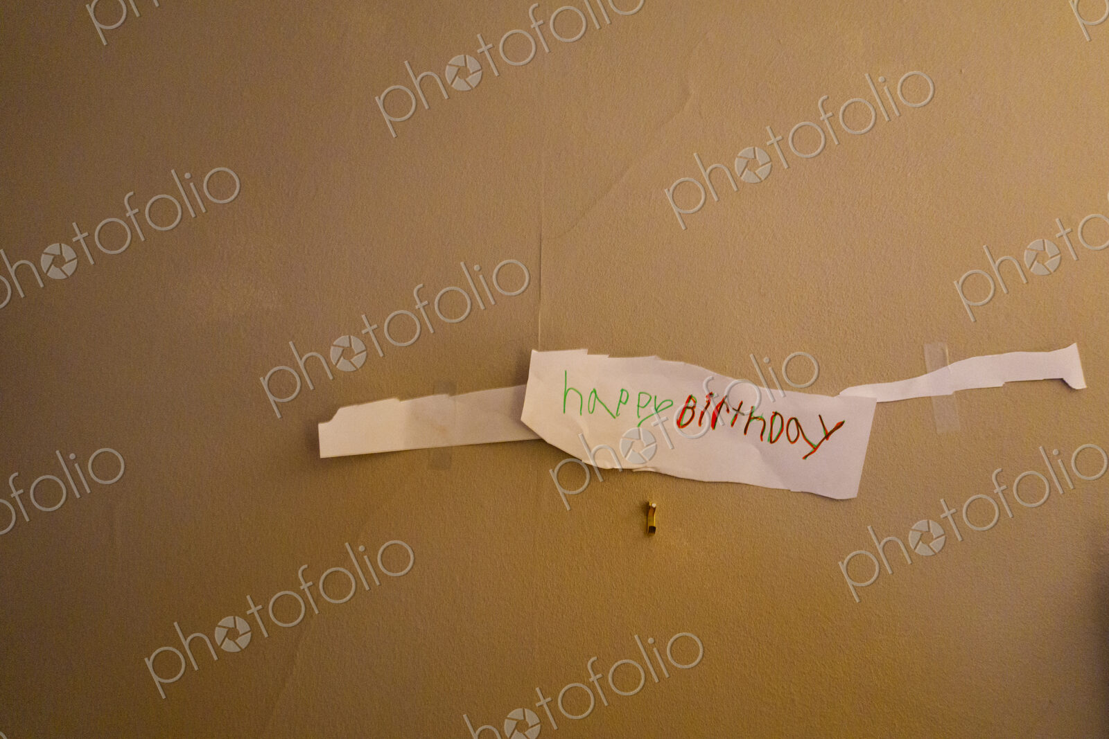 Child drawn happy birthday sign on wall
