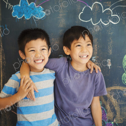Children in school. Two boys standing with their arms around each other's shoulders by… Children in school. Two boys standing with their arms around each other's shoulders by…