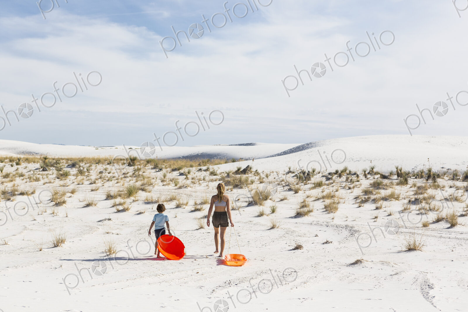 Children pulling sleds, White Sands Nat’l Monument, NM