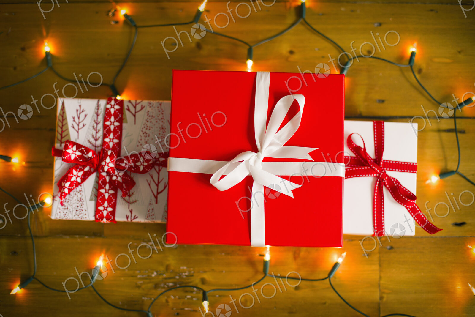 Christmas decorations. Gift boxes tied with a ribbon and fairy lights.