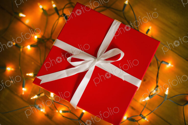 Christmas decorations. Gift boxes tied with a ribbon and fairy lights.