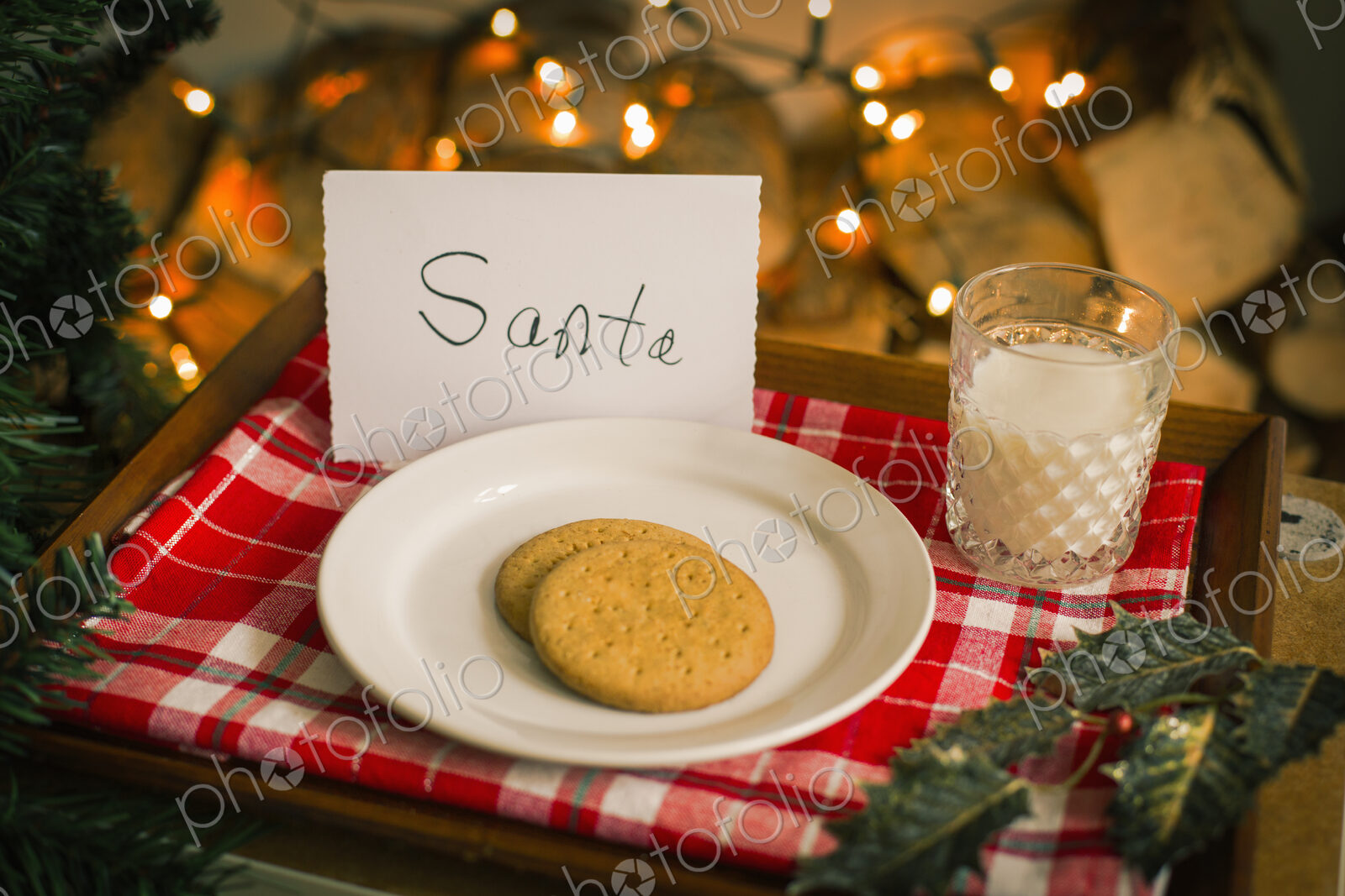 Christmas preparations. A plate with biscuits and a glass of milk on a tray for Santa.