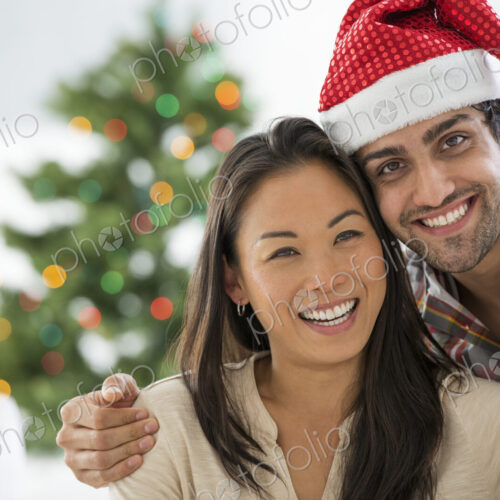 Christmas time. Celebrating the holidays. A man in a Father Christmas hat. At home. A… Christmas time. Celebrating the holidays. A man in a Father Christmas hat. At home. A…