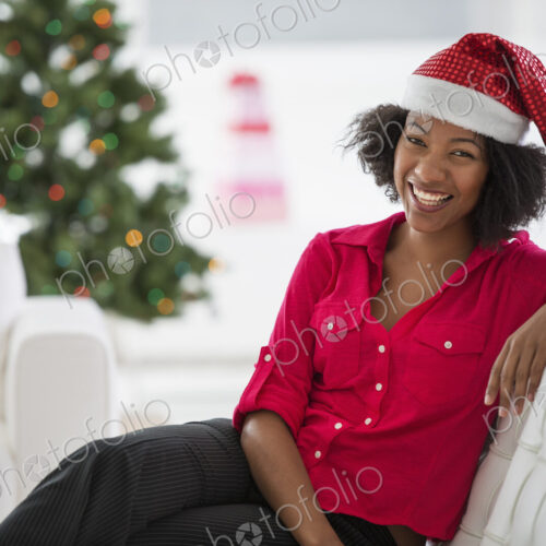 Christmas time. Celebrating the holidays. A woman wearing a red and white Father… Christmas time. Celebrating the holidays. A woman wearing a red and white Father…