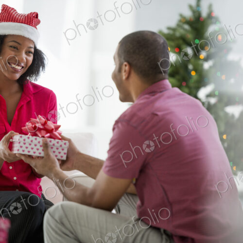 Christmas time. Celebrating the holidays. A woman wearing a red and white Father… Christmas time. Celebrating the holidays. A woman wearing a red and white Father…