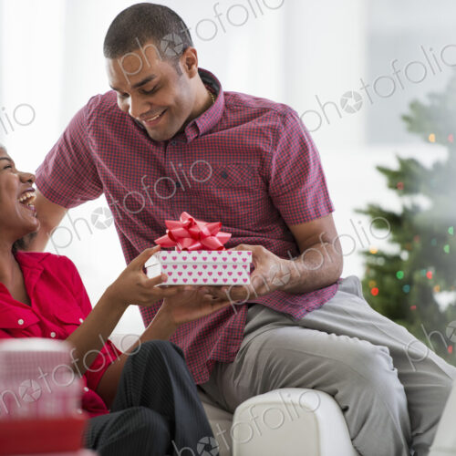 Christmas time. Celebrating the holidays. A woman wearing a red and white Father… Christmas time. Celebrating the holidays. A woman wearing a red and white Father…