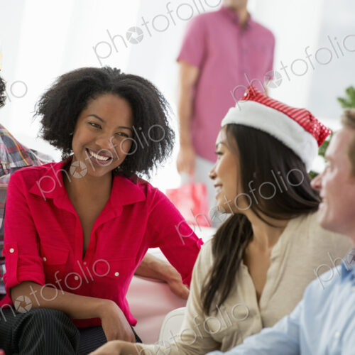 Christmas time. Celebrating the holidays. A woman wearing a red and white Father… Christmas time. Celebrating the holidays. A woman wearing a red and white Father…