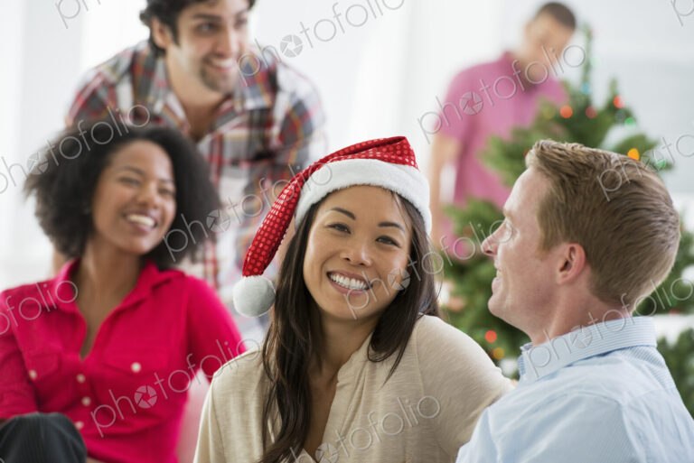 Christmas time. Celebrating the holidays. A woman wearing a red and white Father…
