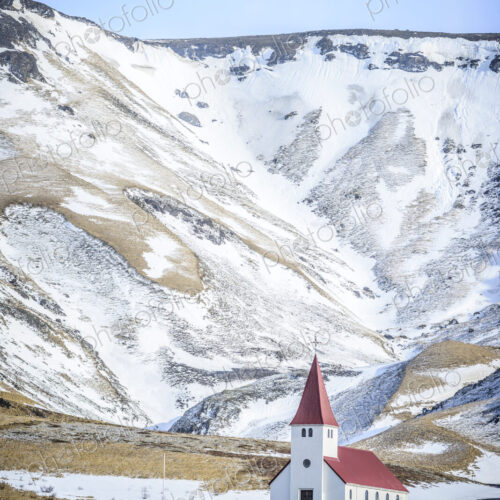 Church under snowy mountains in rural landscape Church under snowy mountains in rural landscape