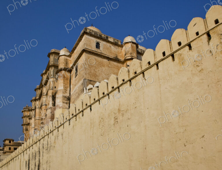 City Palace in Udaipur, Rajasthan, a high fortress wall built around an elegant palace…