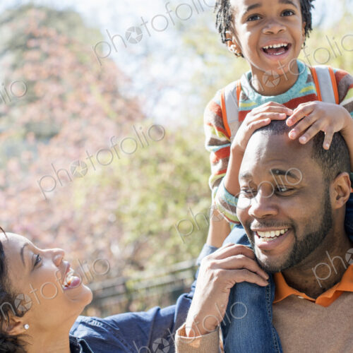 City in spring, A father carrying his son on his shoulders.