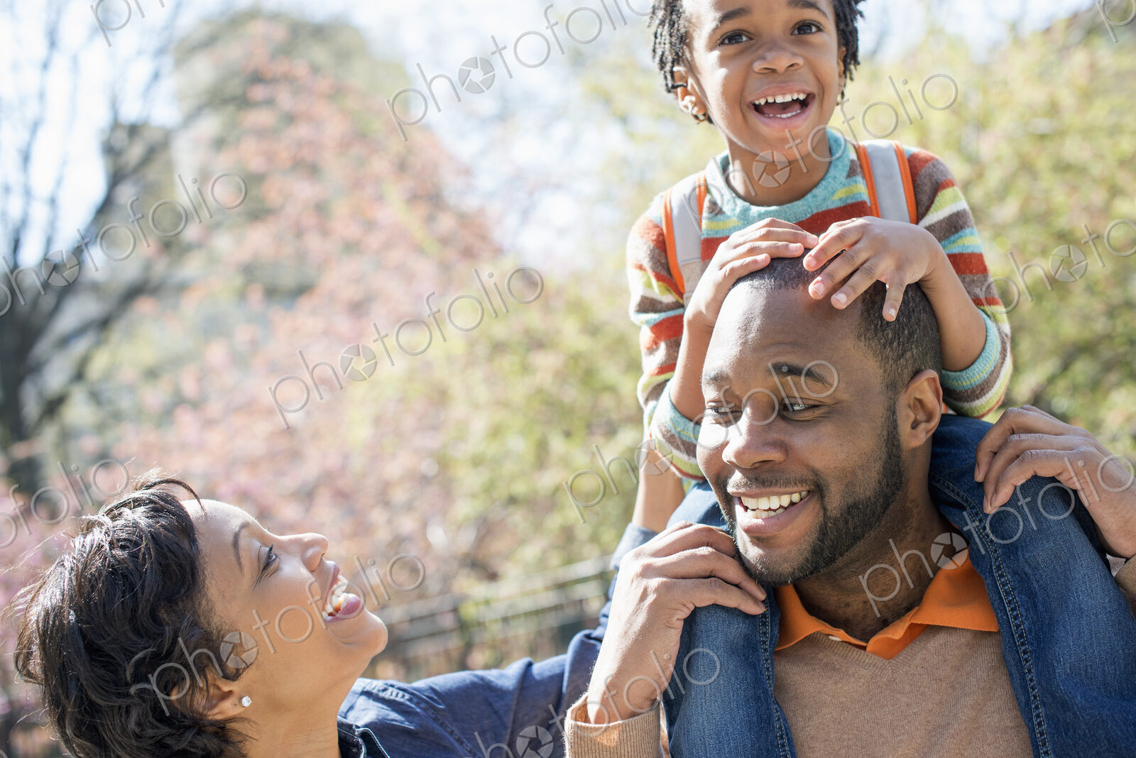 City in spring, A father carrying his son on his shoulders.