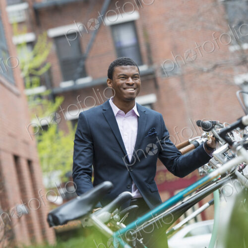 City life in spring. A man in a blue suit, by a bicycle rack in a city park. City life in spring. A man in a blue suit, by a bicycle rack in a city park.