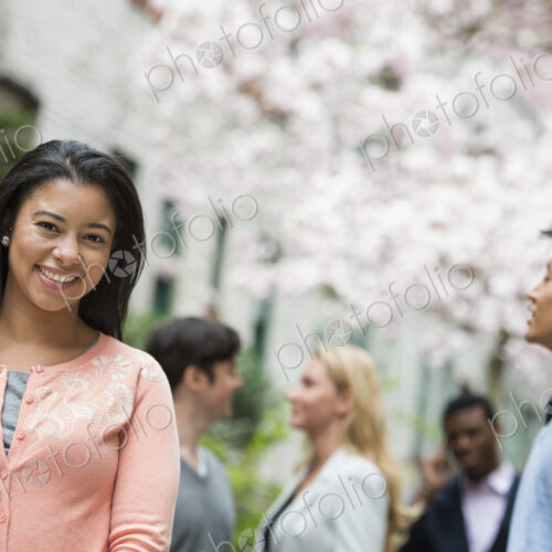 City life in spring. Young people outdoors in a city park. A woman in a pink shirt… City life in spring. Young people outdoors in a city park. A woman in a pink shirt…