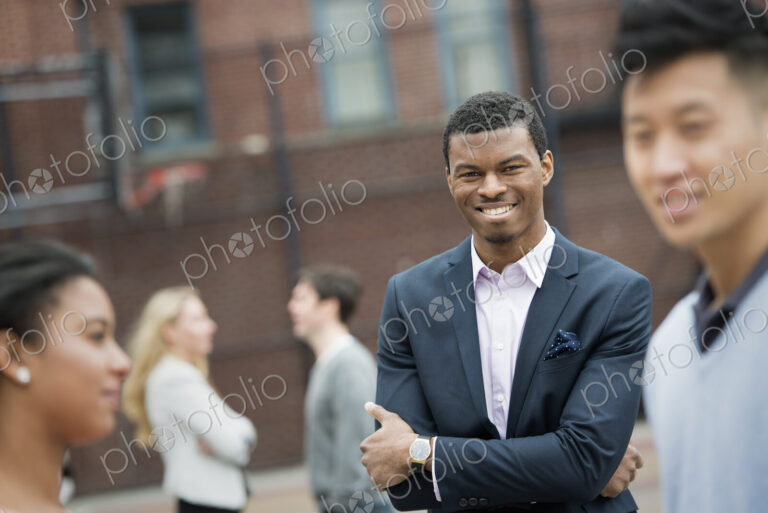 City life in spring. Young people outdoors in a city park. Two people in the…
