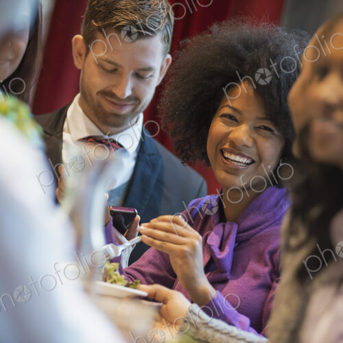 City life. A group of people in a coffee shop, one using a mobile phone, and others… City life. A group of people in a coffee shop, one using a mobile phone, and others…
