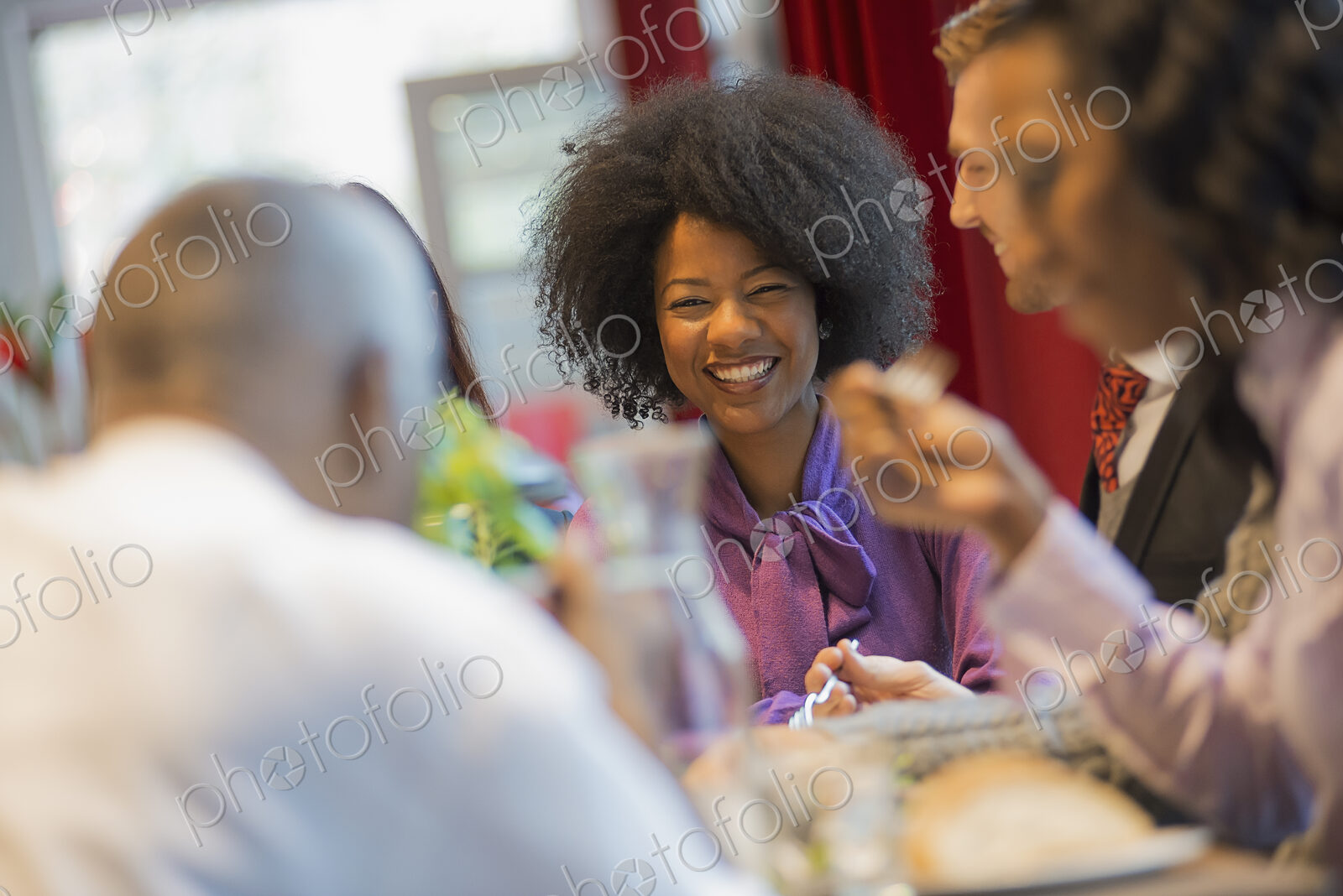 City life. A group of people in a coffee shop, one using a mobile phone, and others…