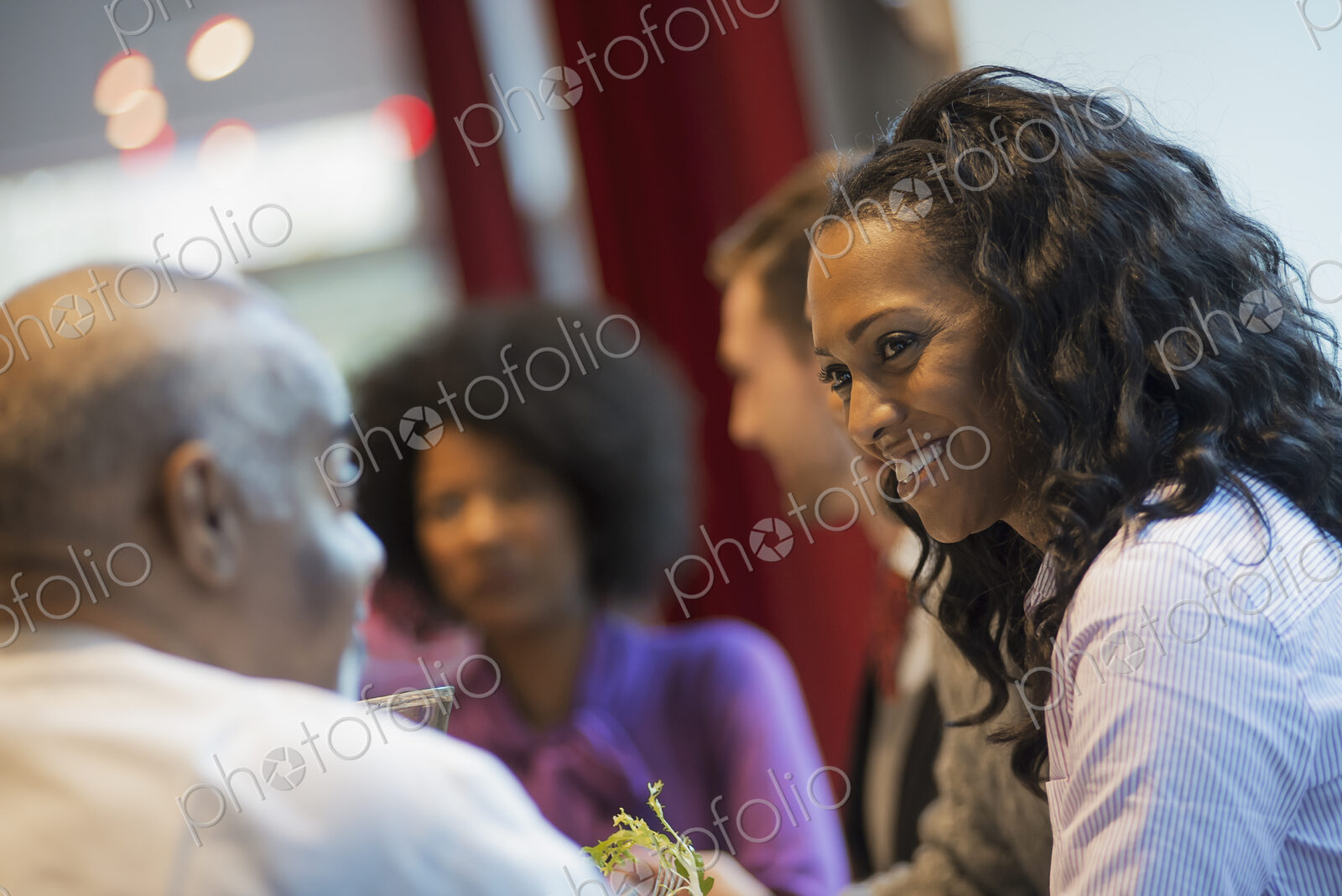 City life. A group of people in a coffee shop, talking to each other. Men and women.
