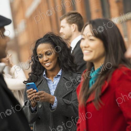 City life. A group of people on the go, keeping in contact, talking to each other. Men… City life. A group of people on the go, keeping in contact, talking to each other. Men…