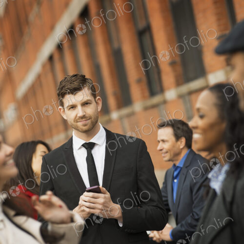 City life. A group of people on the go, keeping in contact, using mobile phones, and… City life. A group of people on the go, keeping in contact, using mobile phones, and…