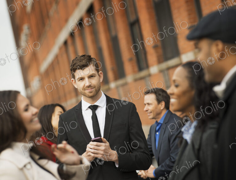 City life. A group of people on the go, keeping in contact, using mobile phones, and…