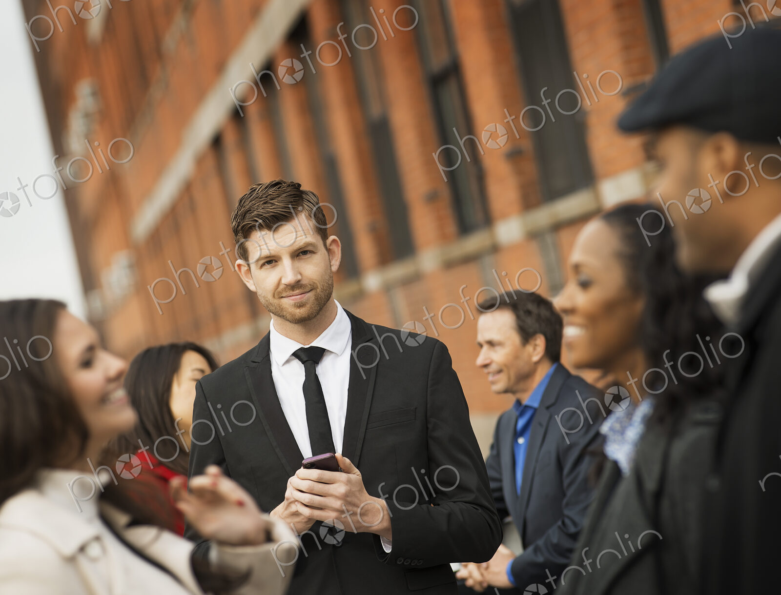 City life. A group of people on the go, keeping in contact, using mobile phones, and…