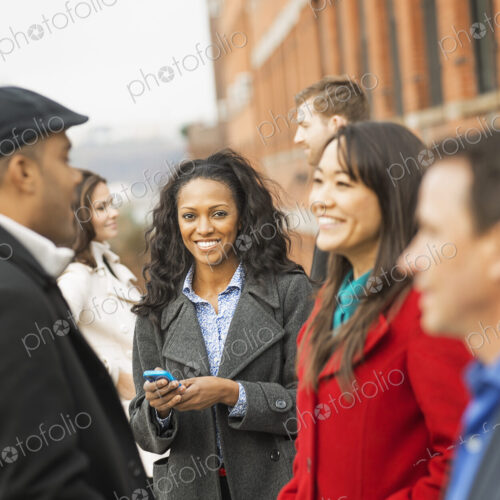 City life. A group of people on the go, keeping in contact, using mobile phones, and… City life. A group of people on the go, keeping in contact, using mobile phones, and…