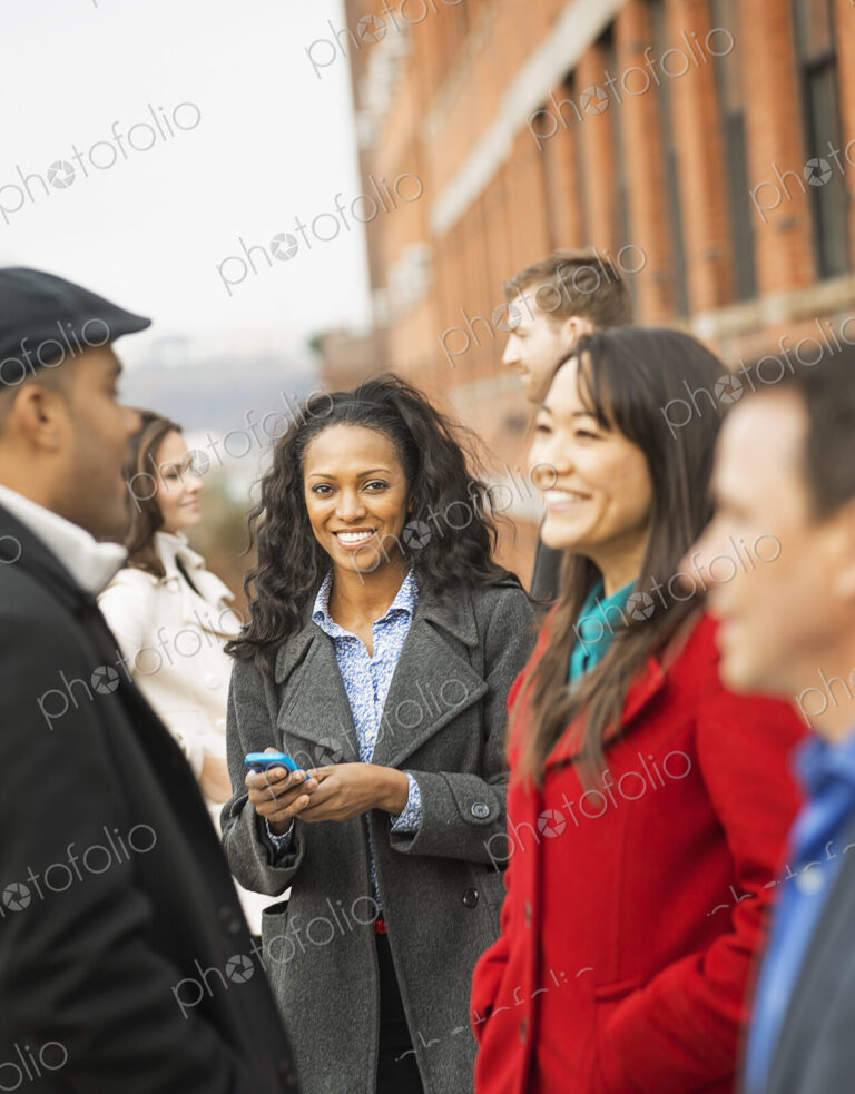 City life. A group of people on the go, keeping in contact, using mobile phones, and…