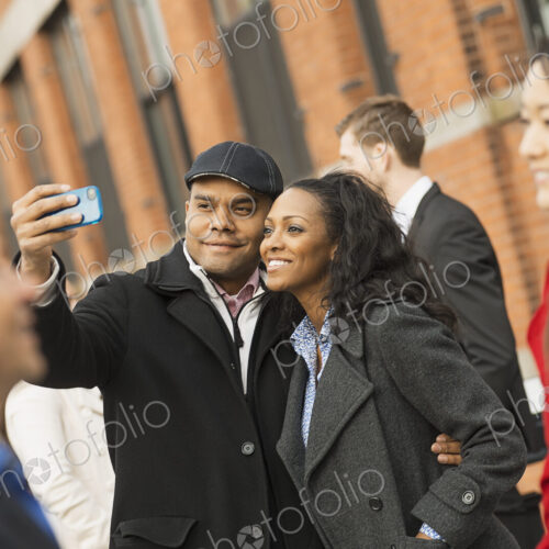 City life. A group of people on the go, keeping in contact, using mobile phones, and… City life. A group of people on the go, keeping in contact, using mobile phones, and…
