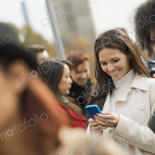 City life. A group of people on the go, keeping in contact, using mobile phones, and… City life. A group of people on the go, keeping in contact, using mobile phones, and…