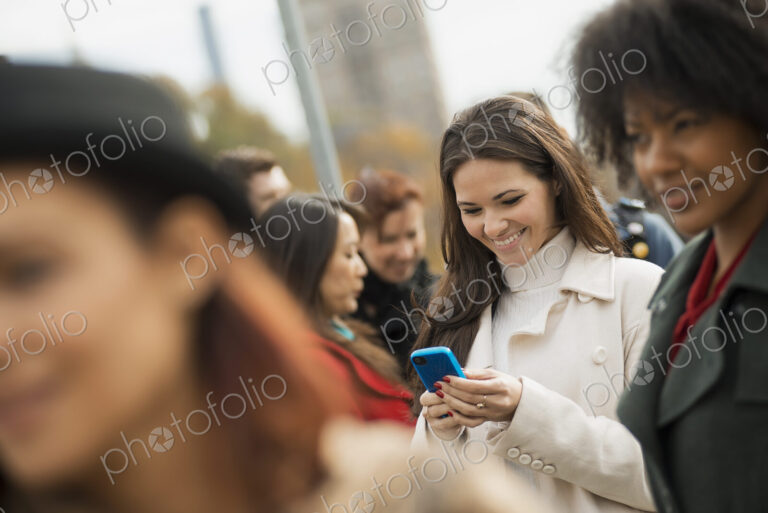 City life. A group of people on the go, keeping in contact, using mobile phones, and…