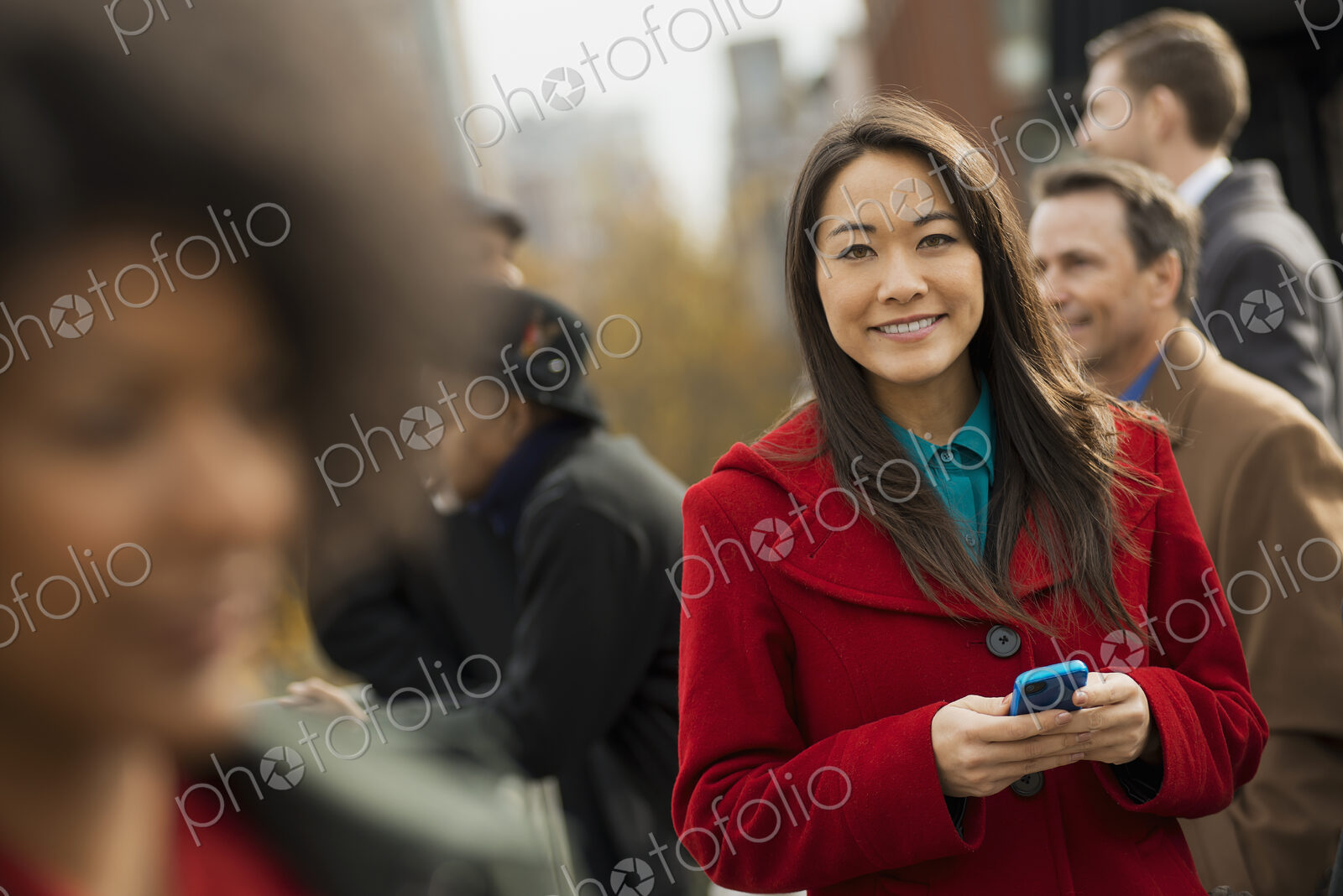 City life. A group of people on the go, keeping in contact, using mobile phones, and…