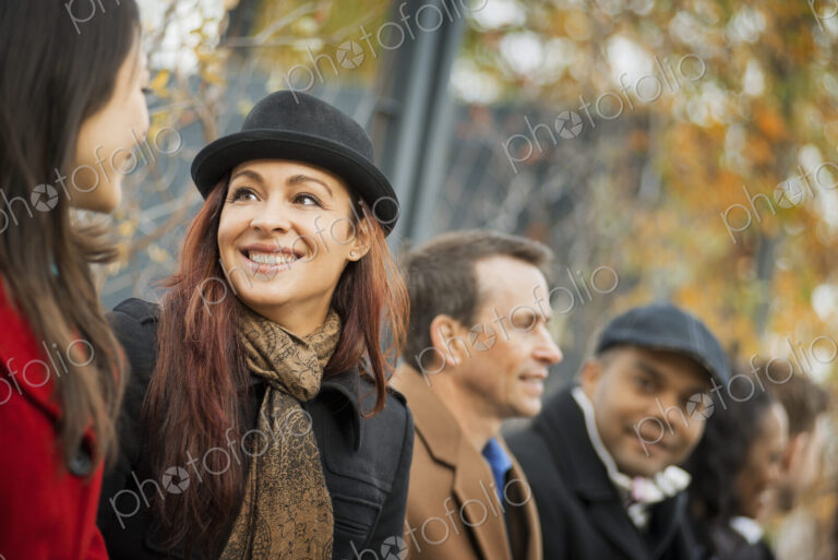 City life. A group of people on the go, keeping in contact, using mobile phones, and…