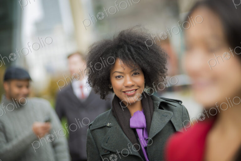 City life. A group of people on the go, keeping in contact, using mobile phones, and…