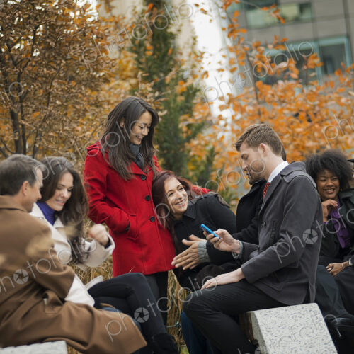 City life. A group of people on the go, keeping in contact, using mobile phones, and… City life. A group of people on the go, keeping in contact, using mobile phones, and…