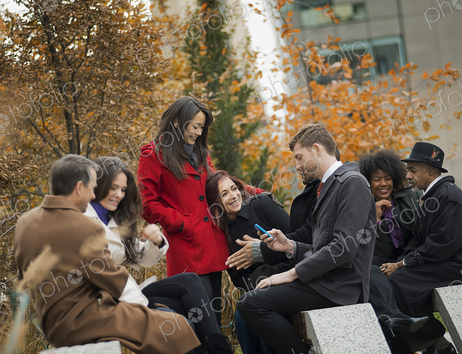 City life. A group of people on the go, keeping in contact, using mobile phones, and…