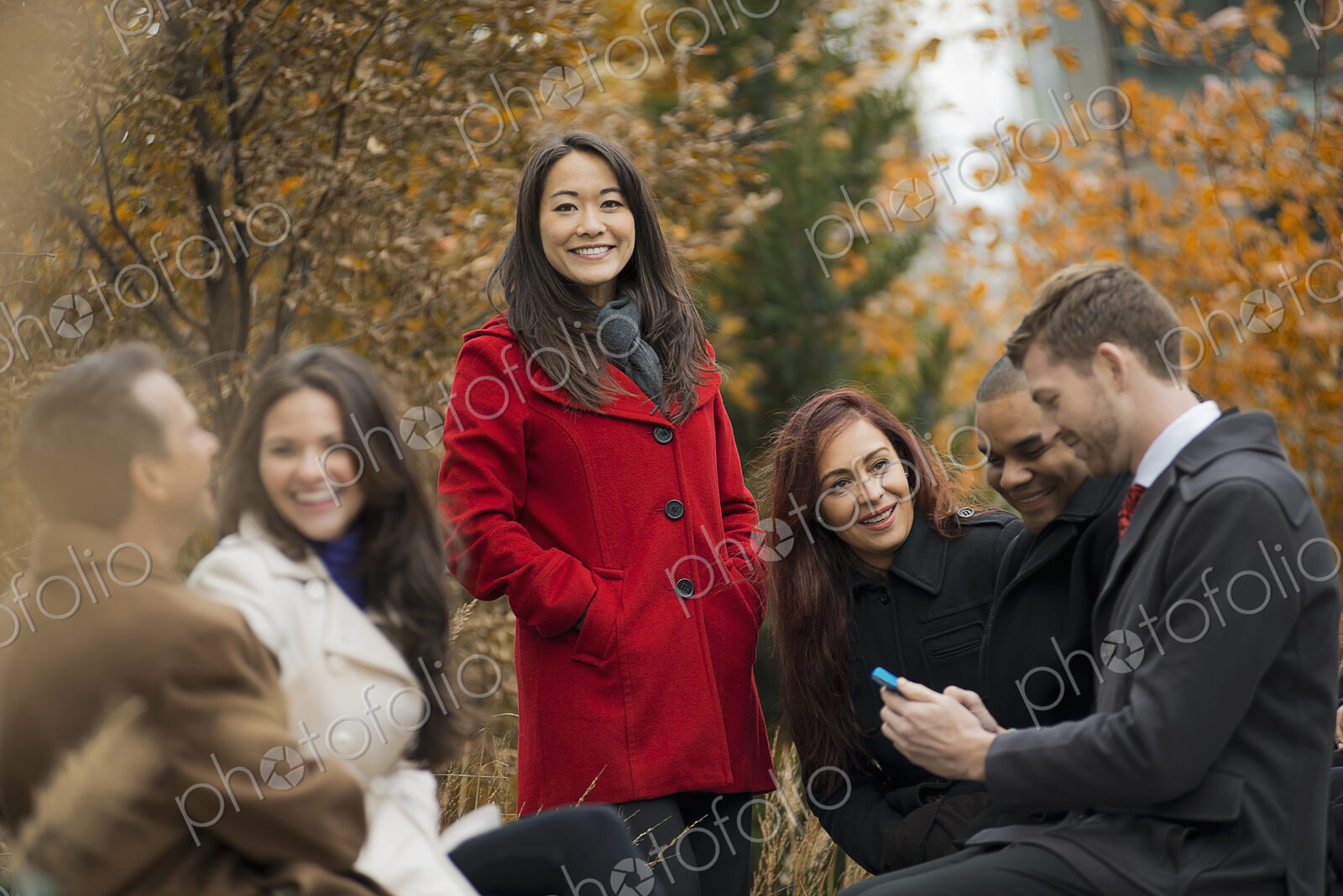 City life. A group of people on the go, keeping in contact, using mobile phones, and…