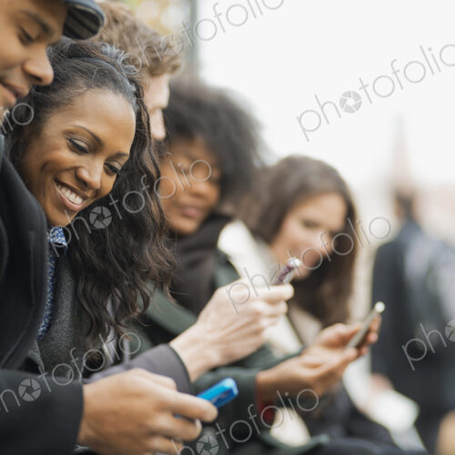 City life. A group of people on the go, keeping in contact, using mobile phones. Men… City life. A group of people on the go, keeping in contact, using mobile phones. Men…