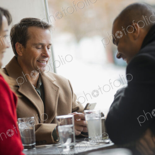 City life. A group of people on the go, using mobile phones, and talking to each… City life. A group of people on the go, using mobile phones, and talking to each…