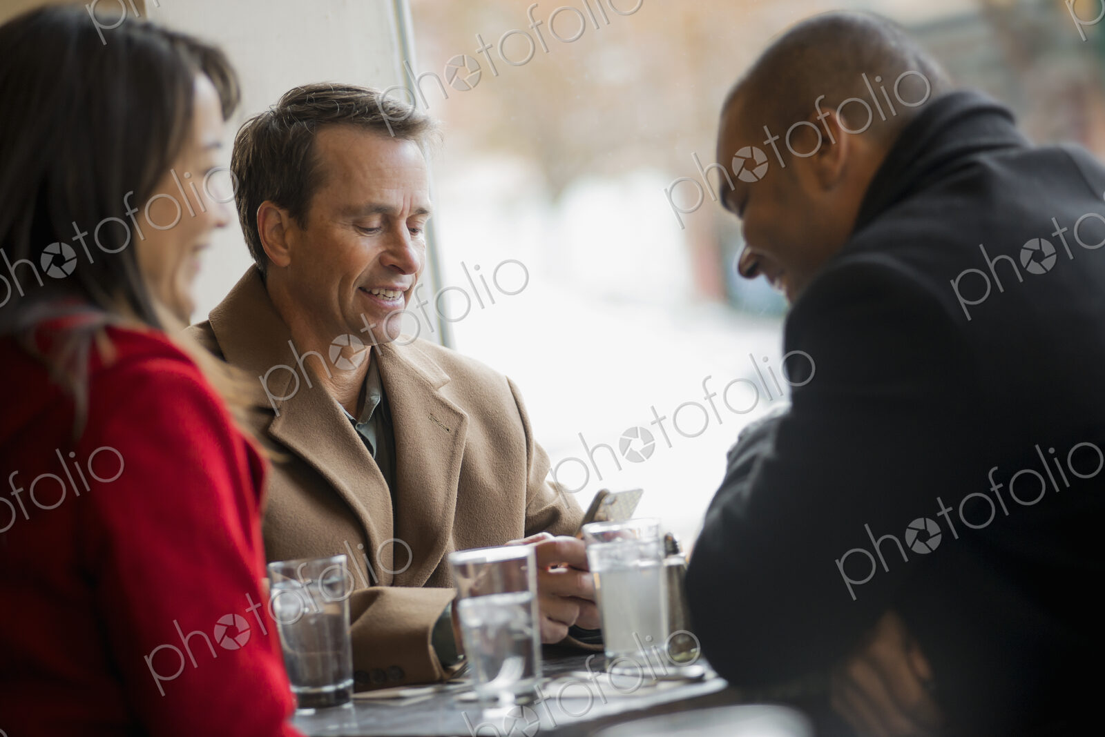 City life. A group of people on the go, using mobile phones, and talking to each…