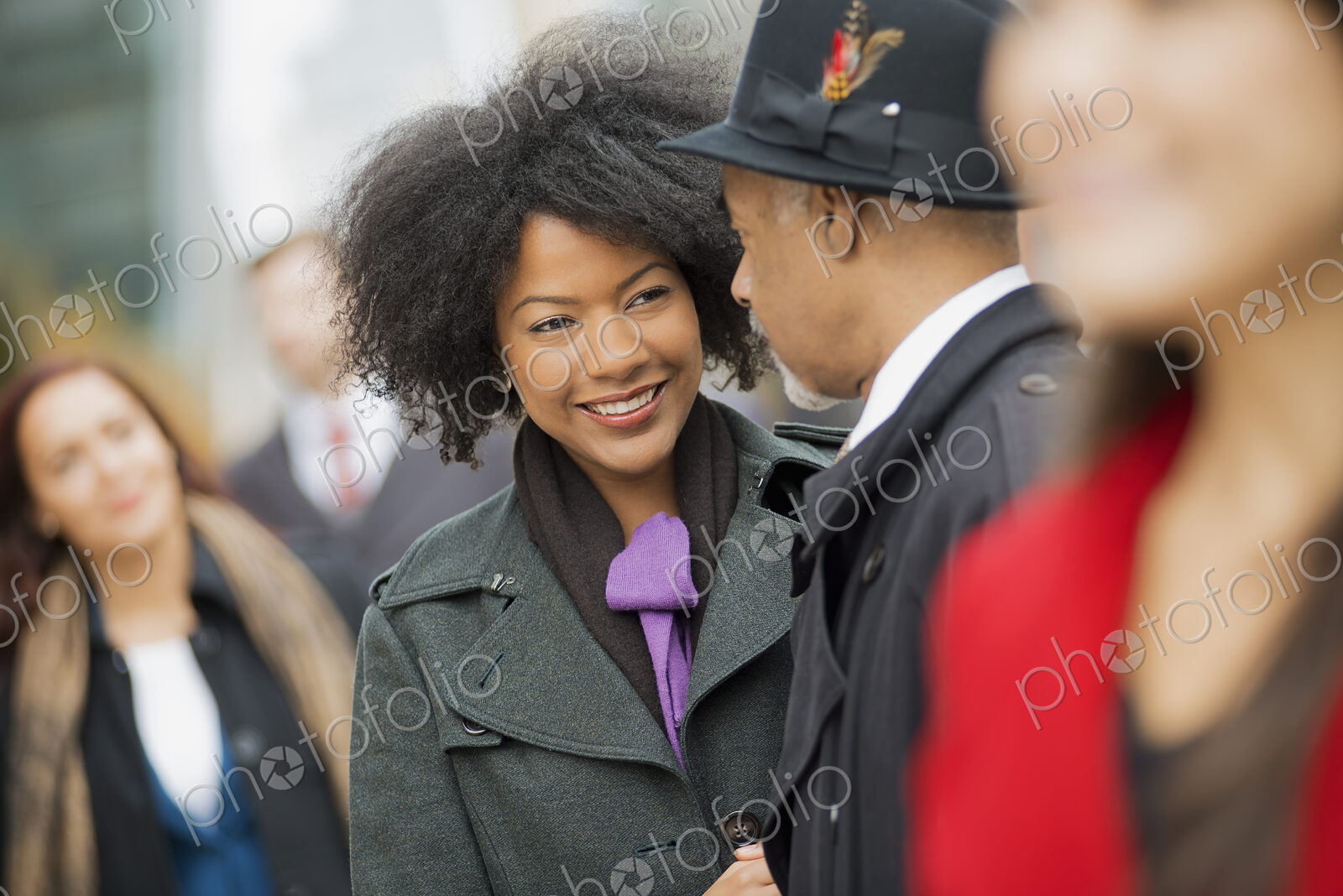 City life. A group of people on the go,on the street. A man and woman standing close…