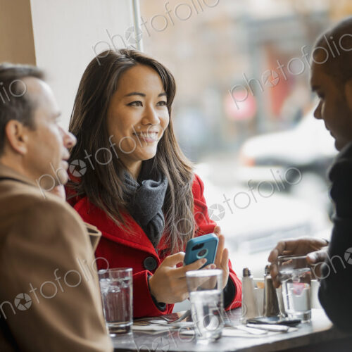 City life. A group of people on the go,using mobile phones, and talking to each other.… City life. A group of people on the go,using mobile phones, and talking to each other.…