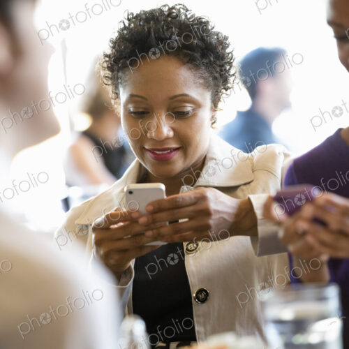 City life. A group of people sitting in a cafe or bar around a table. Men and women… City life. A group of people sitting in a cafe or bar around a table. Men and women…
