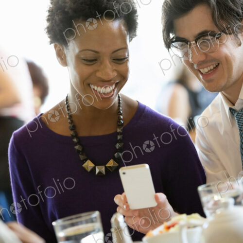City life. A group of people sitting in a cafe or bar around a table. Men and women…